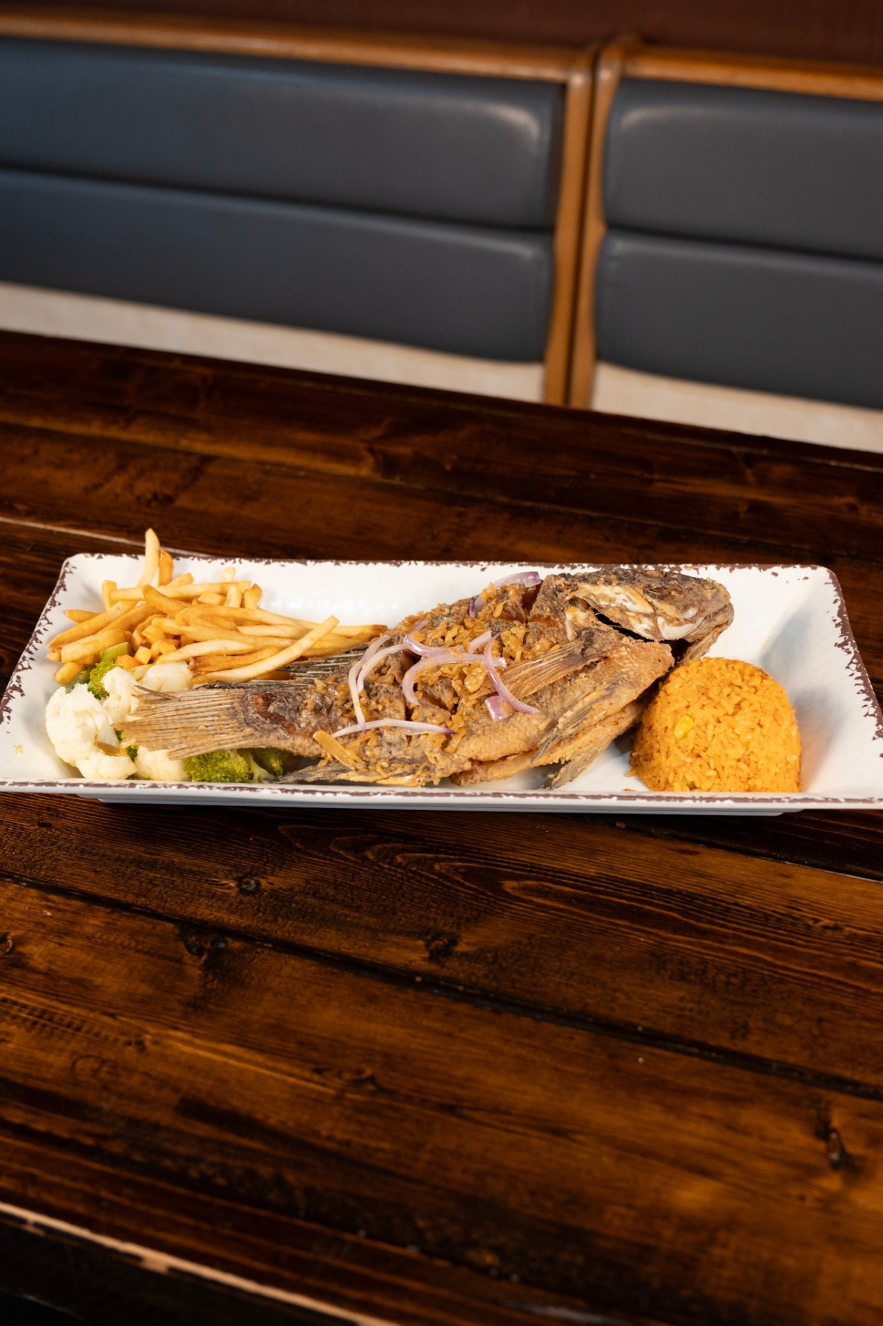 Whole fried mojarra with rice and fries